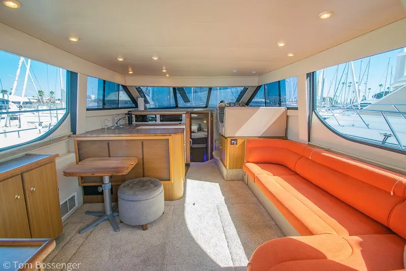 Slide: The Image of Luxurious interior of 2001 Bayliner 3788 Command Bridge Motoryacht with orange seating and wood accents. - 6