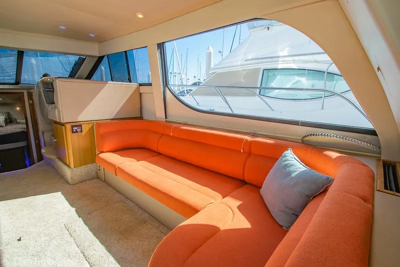 Slide: The Image of Luxurious interior of 2001 Bayliner 3788 Command Bridge Motoryacht with orange seating and large windows. - 7