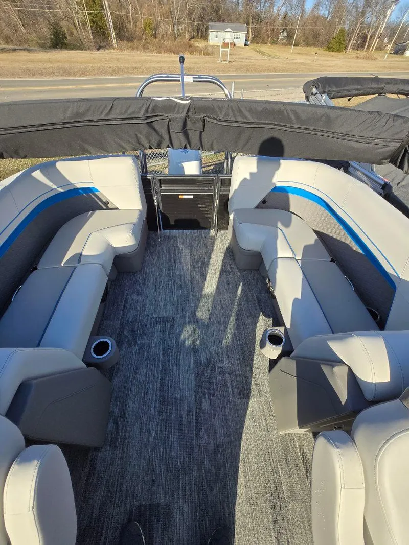 Slide: The Image of Interior of 2025 Quest L Class 20RLS boat with gray seating and blue accents. - 6