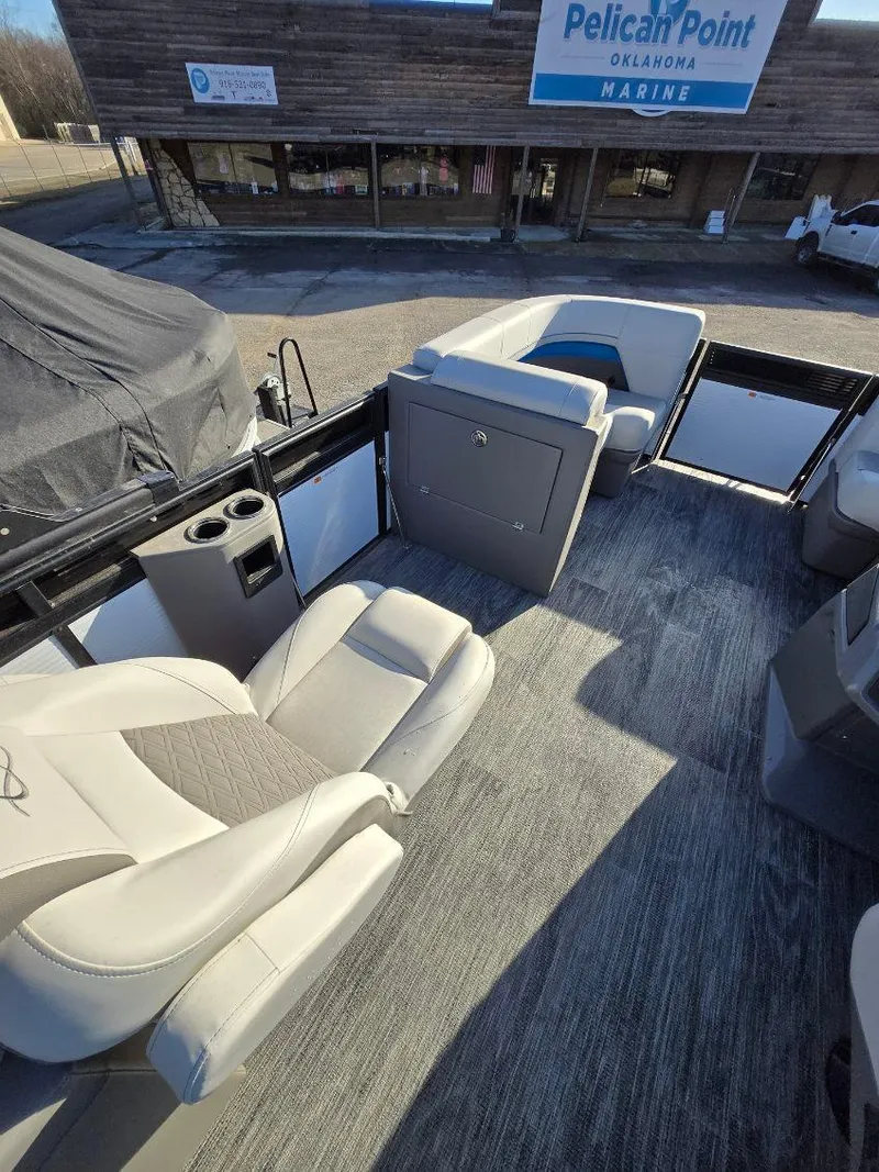 Slide: The Image of 2025 Quest L Class 20RLS boat interior with seating and cup holders at Pelican Point Marine. - 7