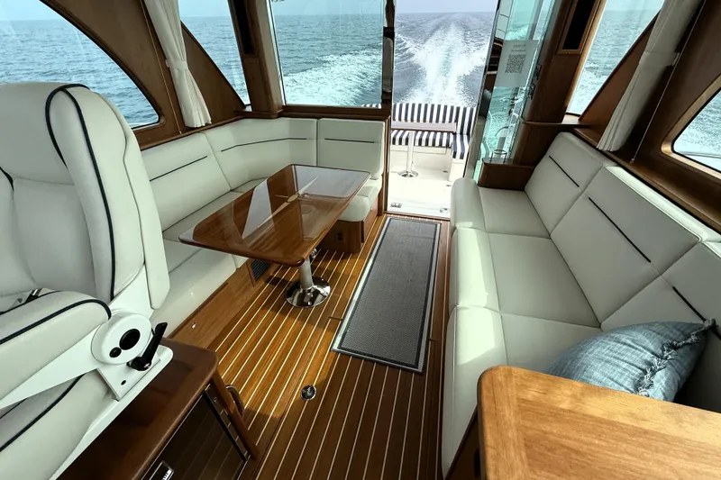 Slide: The Image of Interior of 2025 Sabre 45 Salon Express yacht with elegant seating and ocean view. - 12