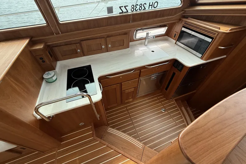 Slide: The Image of Luxurious 2025 Sabre 45 Salon Express yacht kitchen with modern appliances and wooden cabinetry. - 21