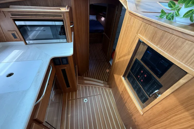 Slide: The Image of Interior of 2025 Sabre 45 Salon Express yacht with modern kitchen and control panel. - 22