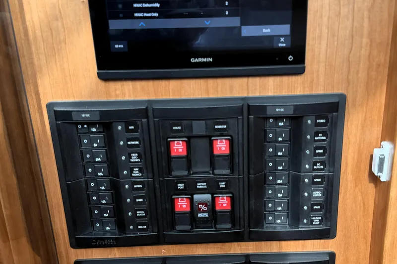 Slide: The Image of Control panel of 2025 Sabre 45 Salon Express with switches and Garmin display. - 23