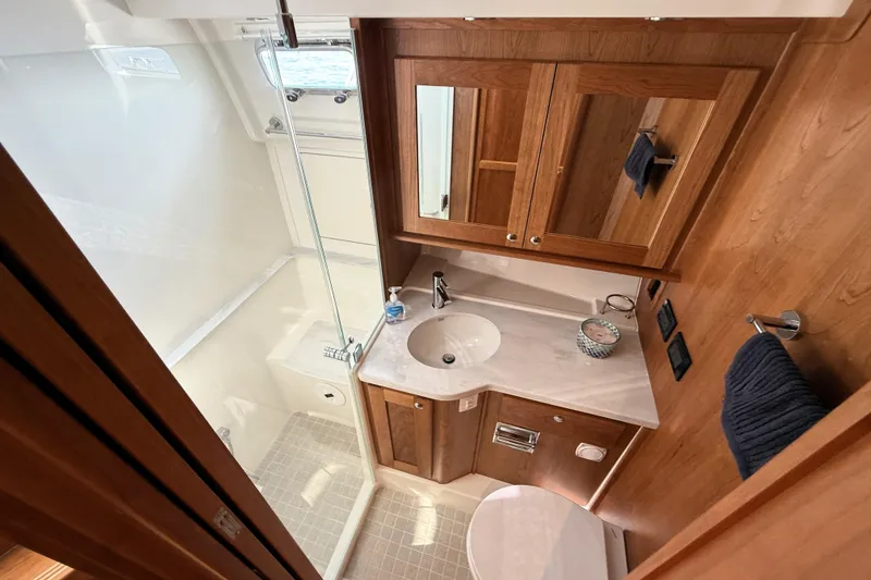 Slide: The Image of Luxurious bathroom in 2025 Sabre 45 Salon Express yacht with wood accents and modern fixtures. - 27