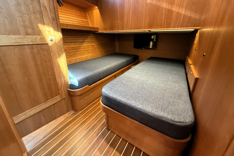 Slide: The Image of Interior cabin of 2025 Sabre 45 Salon Express with twin beds and wooden finish. - 28