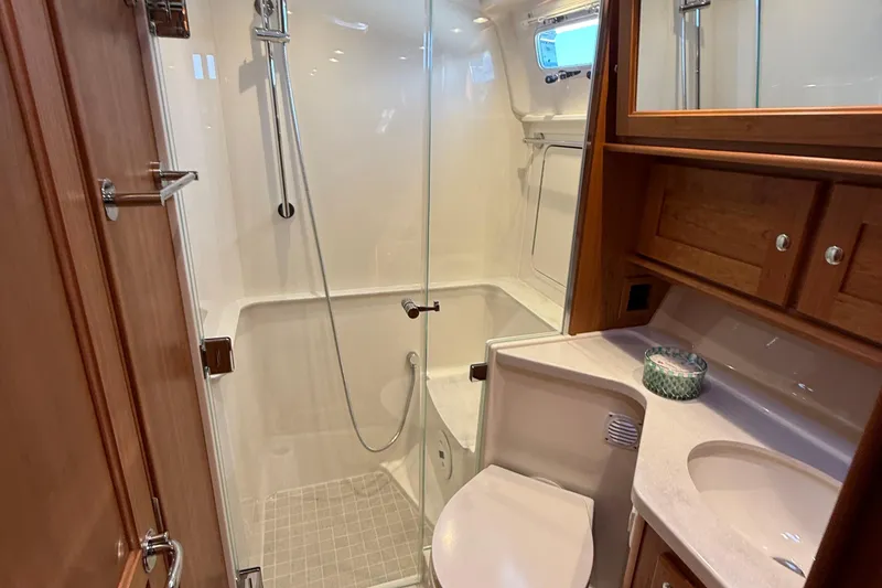 Slide: The Image of Luxurious bathroom in 2025 Sabre 45 Salon Express yacht with shower and wooden cabinetry. - 31