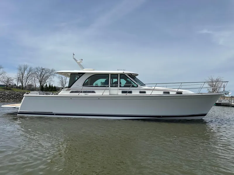 Slide: The Image of 2025 Sabre 45 Salon Express yacht on calm water, side view. - 33