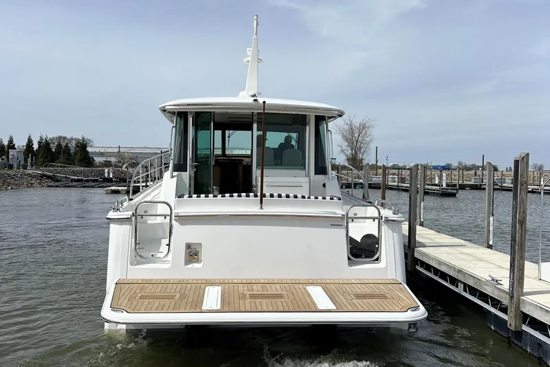 Slide: The Image of 2025 Sabre 45 Salon Express yacht docked at marina, rear view. - 35