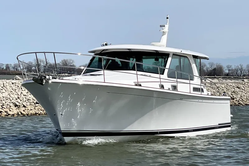 Slide: The Image of 2025 Sabre 45 Salon Express cruising on water, sleek white design, modern luxury yacht. - 5