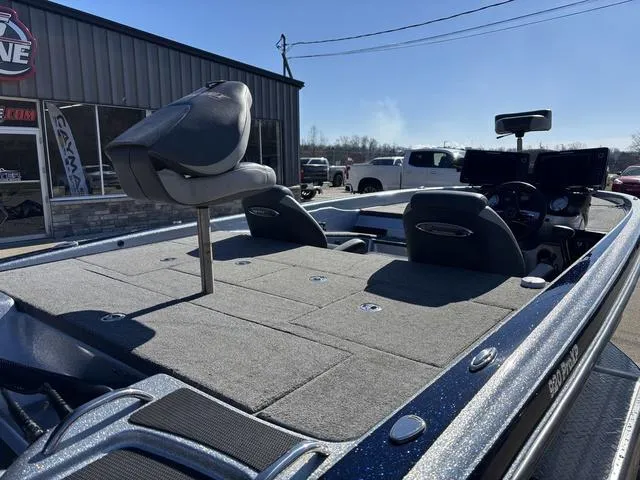 Slide: The Image of 2021 Phoenix 920 PRO XP boat with spacious deck and seating, parked outdoors. - 4