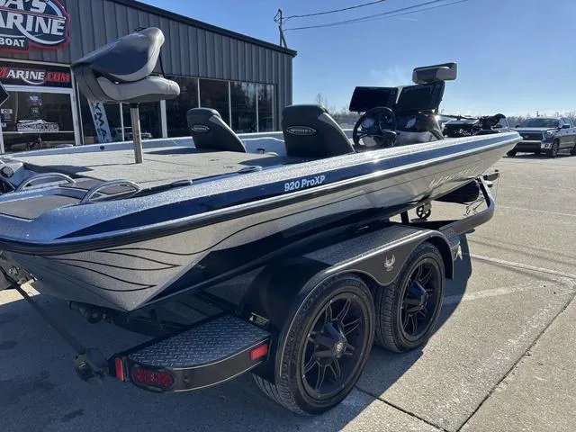 Slide: The Image of 2021 Phoenix 920 PRO XP boat on trailer, parked outside a marine shop. - 5