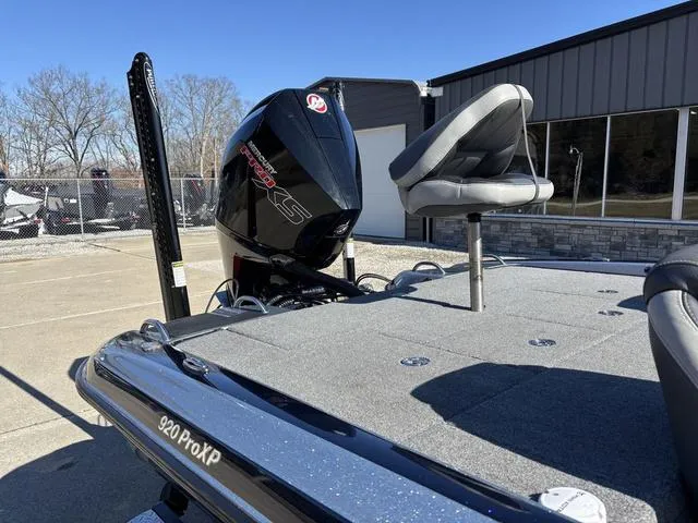 Slide: The Image of 2021 Phoenix 920 PRO XP boat with motor and seating, parked outdoors. - 8