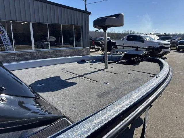 Slide: The Image of 2021 Phoenix 920 PRO XP boat deck with seat, parked outside a building. - 9