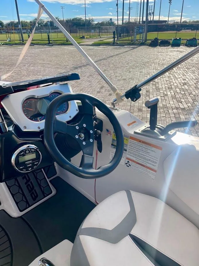 Slide: The Image of 2017 Scarab 165 HO boat interior with steering wheel and dashboard controls. - 11
