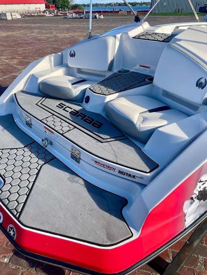 Slide: The Image of 2017 Scarab 165 HO boat with sleek seating and Rotax engine branding. - 16