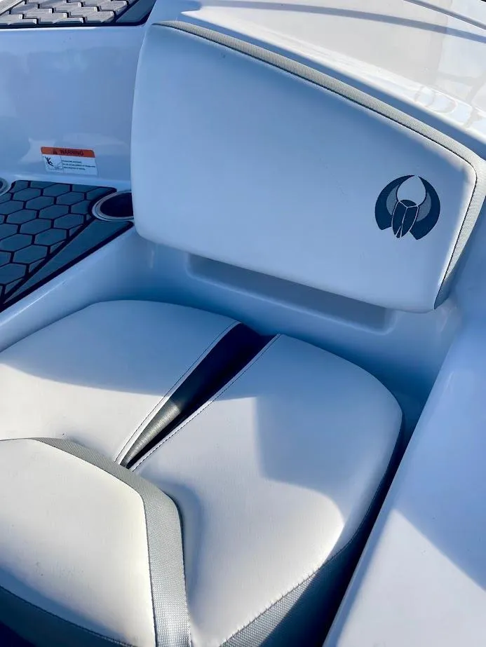 Slide: The Image of 2017 Scarab 165 HO boat seat with logo, featuring sleek white upholstery. - 17