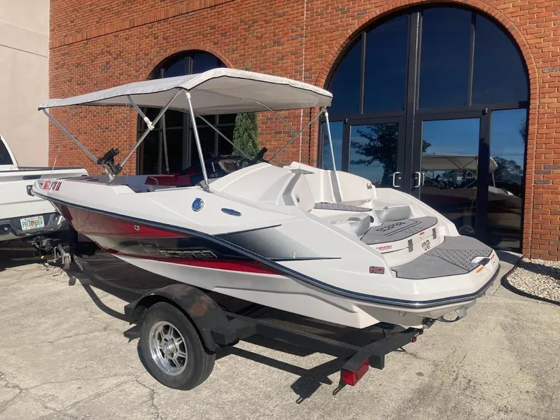 Slide: The Image of 2017 Scarab 165 HO boat with canopy on trailer, parked outside brick building. - 20