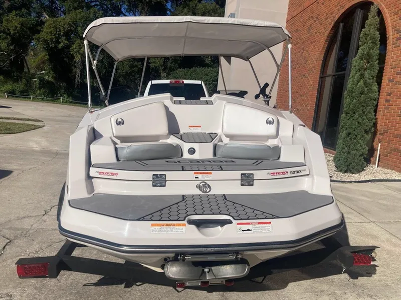 Slide: The Image of 2017 Scarab 165 HO boat with seating and canopy, parked outdoors. - 21