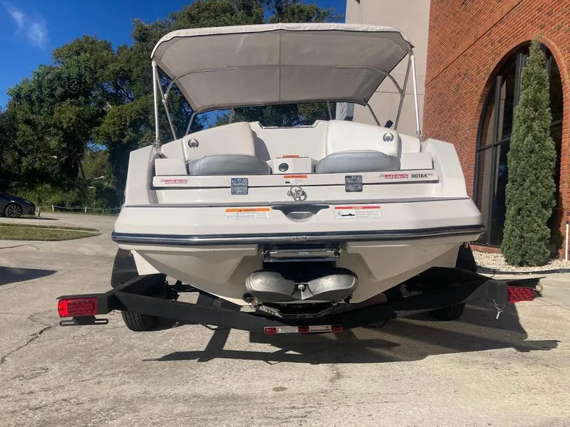Slide: The Image of 2017 Scarab 165 HO boat, rear view, parked on trailer, with canopy, sunny day. - 22