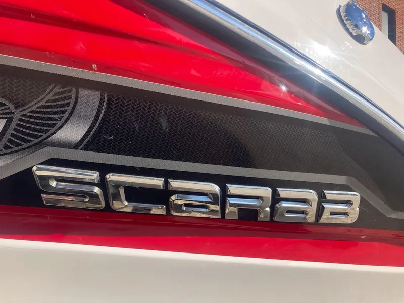 Slide: The Image of 2017 Scarab 165 HO boat logo with red and black accents. - 26