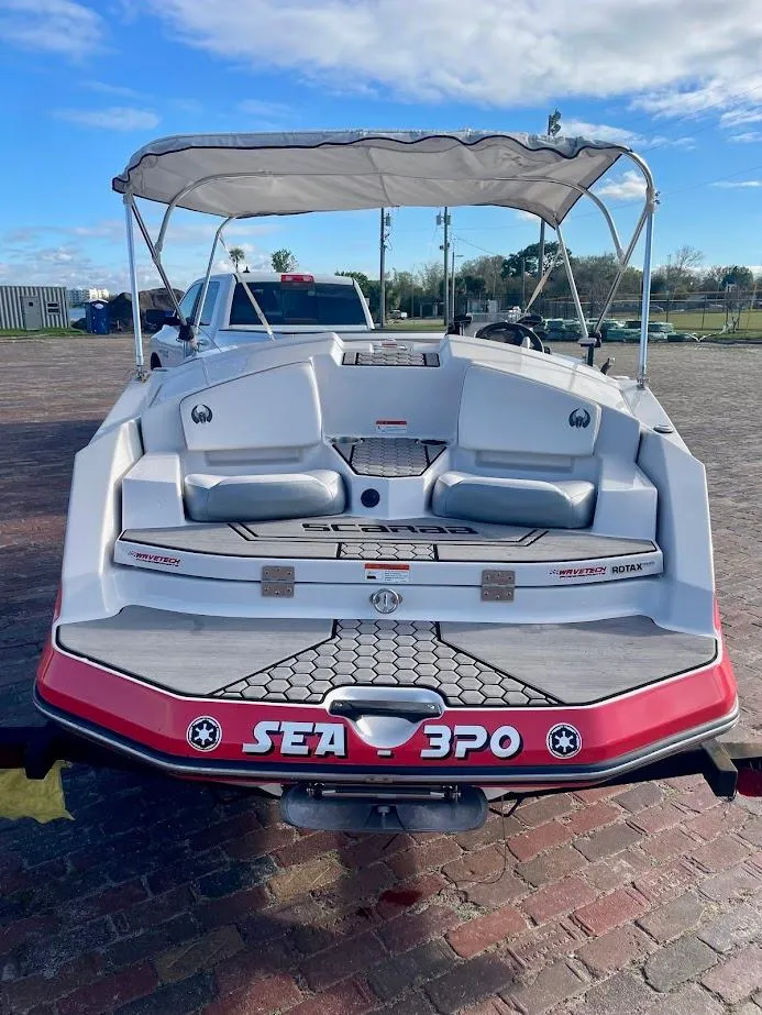 Slide: The Image of 2017 Scarab 165 HO boat with canopy, parked on brick pavement. - 3