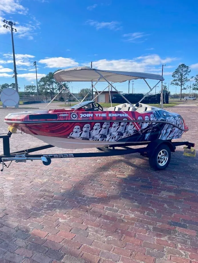 Slide: The Image of 2017 Scarab 165 HO boat with custom "Join the Empire" graphics on a trailer. - 5