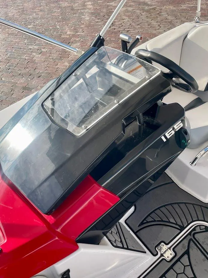 Slide: The Image of 2017 Scarab 165 HO boat dashboard with steering wheel and controls. - 8