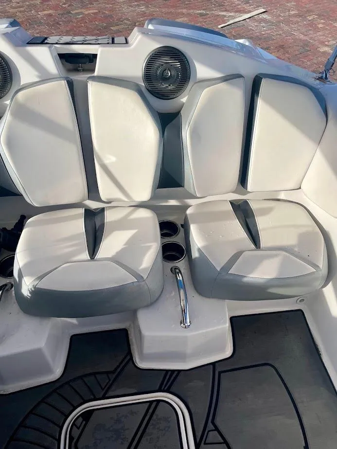 Slide: The Image of 2017 Scarab 165 HO boat interior with white and gray seating and cup holders. - 9
