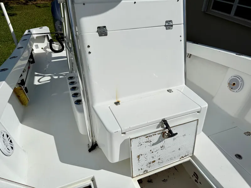 Slide: The Image of 2014 Conch 27 CC boat interior with storage compartment and seating area. - 10