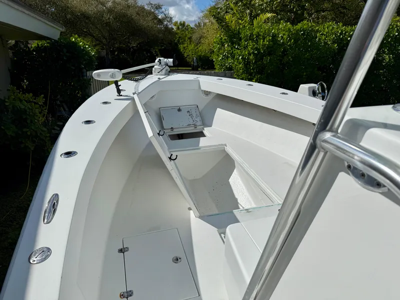 Slide: The Image of 2014 Conch 27 CC boat interior, featuring spacious deck and storage compartments. - 12