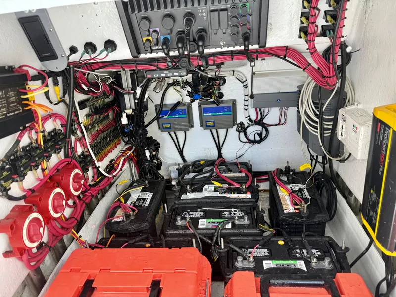 Slide: The Image of Electrical system setup in a 2014 Conch 27 CC boat, featuring batteries and wiring. - 14