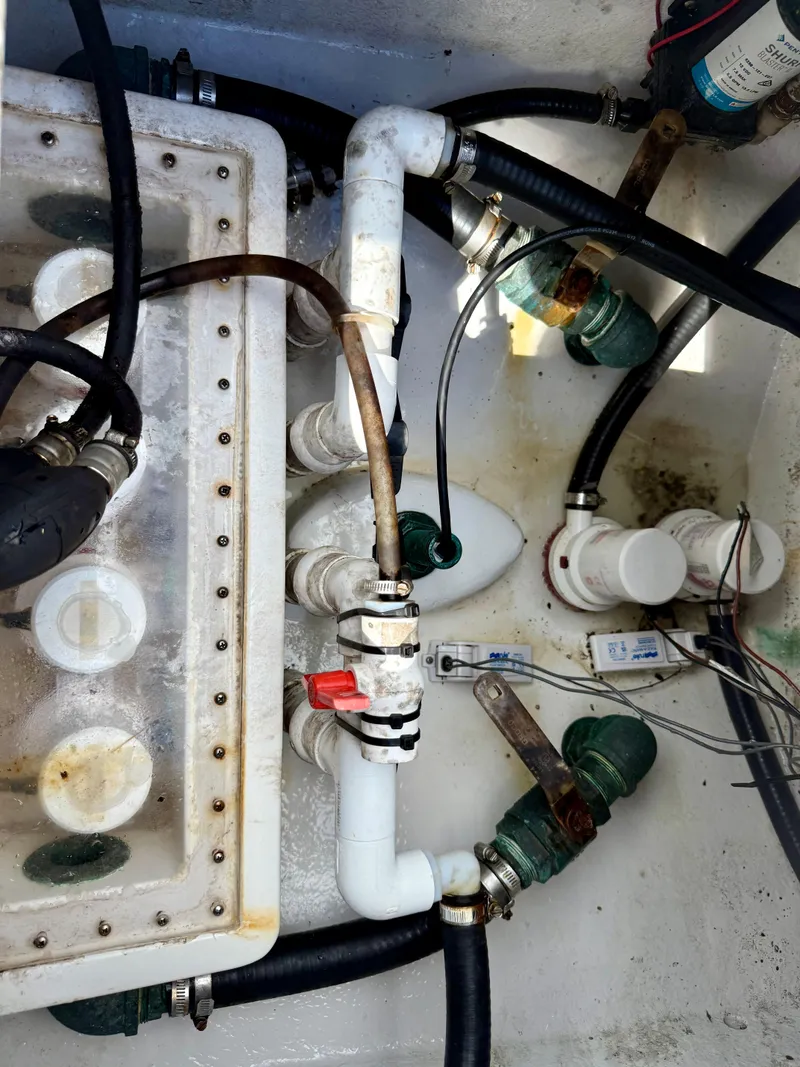 Slide: The Image of 2014 Conch 27 CC boat plumbing system with pipes and valves. - 15
