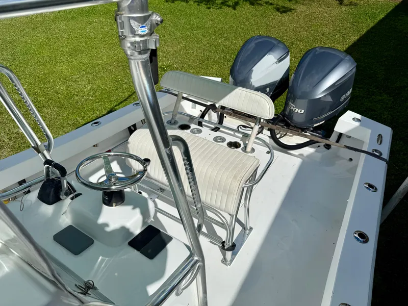 Slide: The Image of 2014 Conch 27 CC boat with dual outboard motors and sleek interior design. - 3