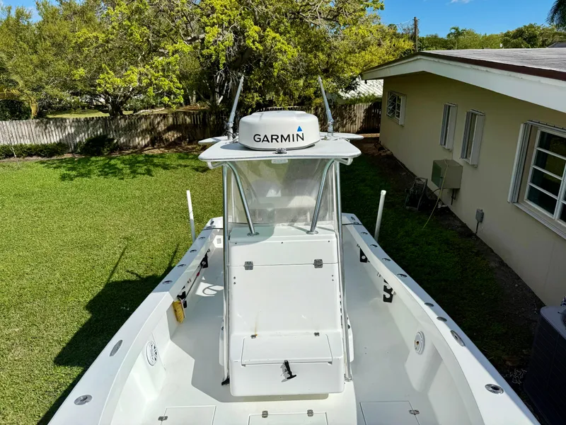 Slide: The Image of 2014 Conch 27 CC boat with Garmin equipment, parked in a grassy yard. - 4