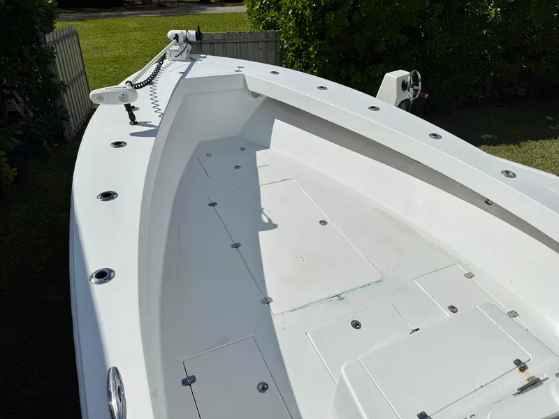 Slide: The Image of 2014 Conch 27 CC boat deck, spacious and clean, with fishing rod holders. - 5