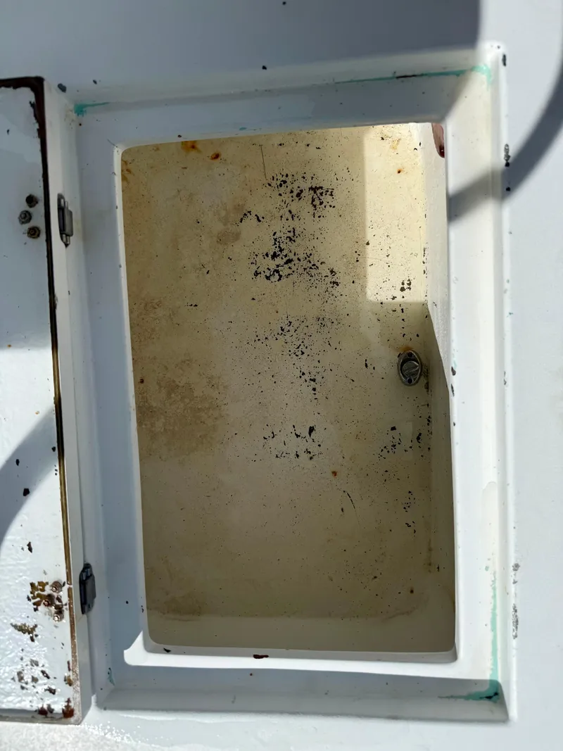 Slide: The Image of Open storage compartment on a 2014 Conch 27 CC boat. - 7