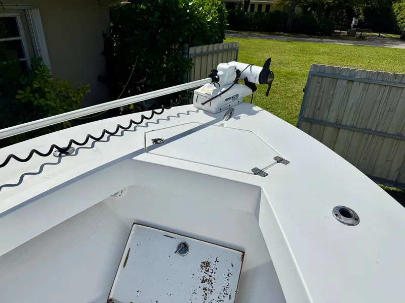 Slide: The Image of 2014 Conch 27 CC boat with trolling motor on deck, in a residential backyard. - 9