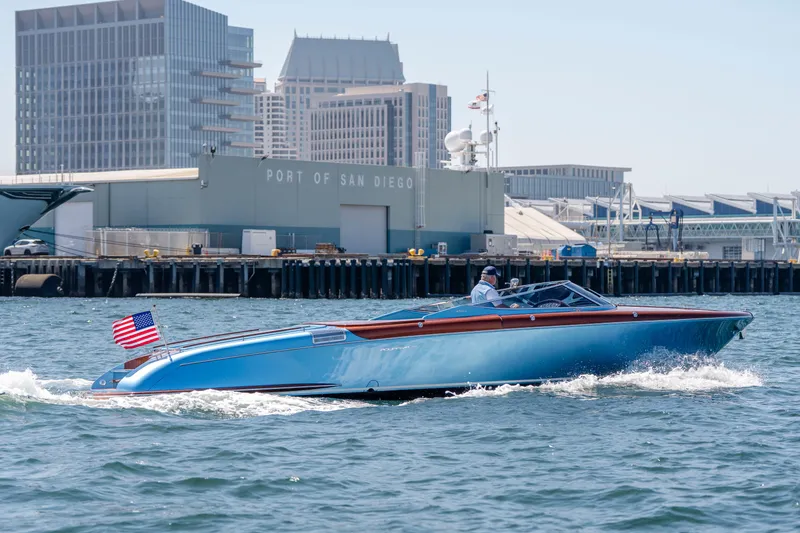 Slide: The Image of 2025 Riva Aquariva 33 cruising near Port of San Diego, American flag displayed. - 10
