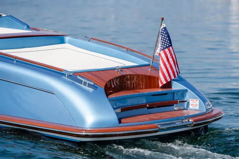 Slide: The Image of 2025 Riva Aquariva 33 boat with American flag on calm water. - 12