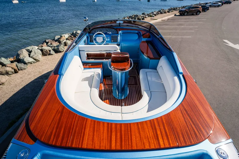 Slide: The Image of 2025 Riva Aquariva 33 luxury boat with elegant wood finish, docked by the sea. - 14