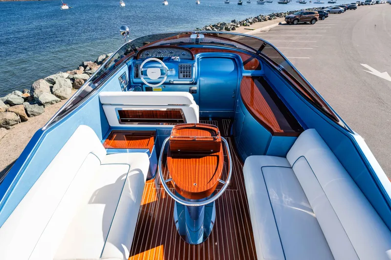 Slide: The Image of 2025 Riva Aquariva 33 luxury yacht interior with elegant seating and wooden accents by the sea. - 15