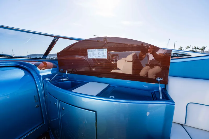 Slide: The Image of 2025 Riva Aquariva 33 interior with sleek blue design and reflective surfaces. - 17