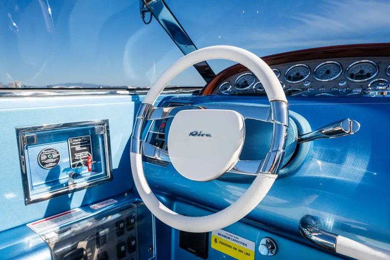 Slide: The Image of Steering wheel of 2025 Riva Aquariva 33, featuring sleek blue dashboard design. - 19