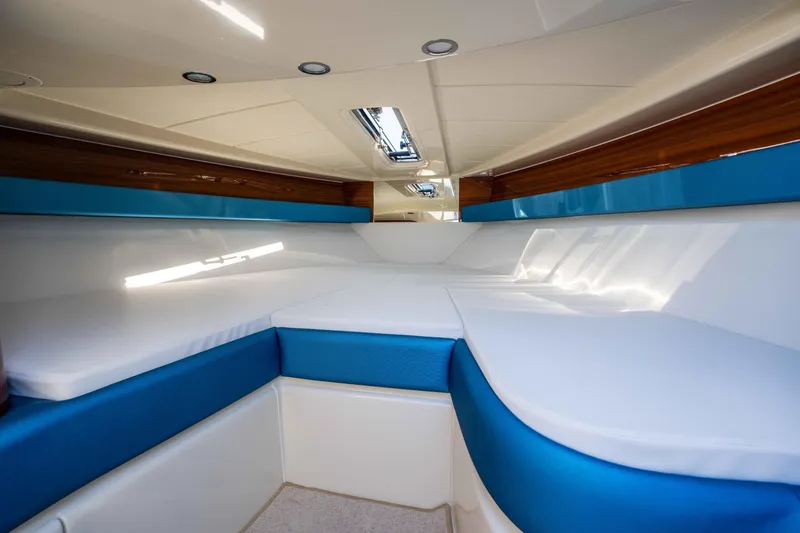 Slide: The Image of 2025 Riva Aquariva 33 cabin interior with blue and white seating, modern design. - 22