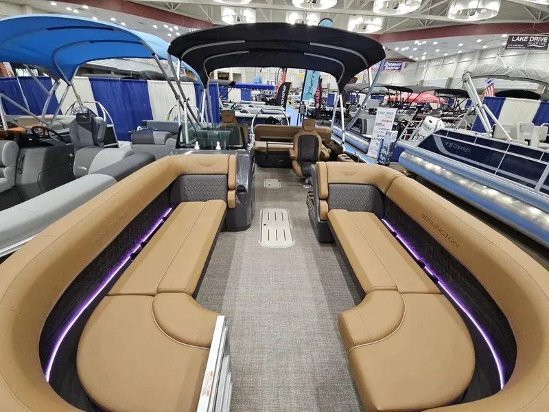 Slide: The Image of 2025 Bennington M Swingback 24 MSB pontoon boat interior at a boat show. - 2