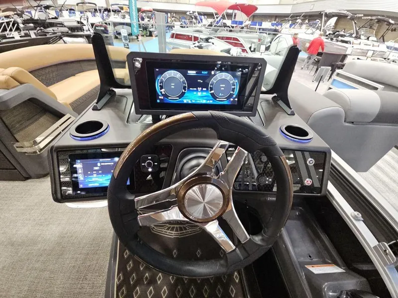 Slide: The Image of 2025 Bennington M Swingback 24 MSB dashboard with modern steering and digital displays. - 4