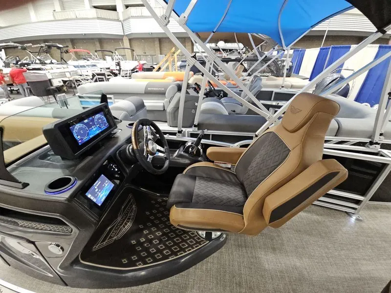 Slide: The Image of 2025 Bennington M Swingback 24 MSB boat interior with modern helm and luxurious seating. - 5