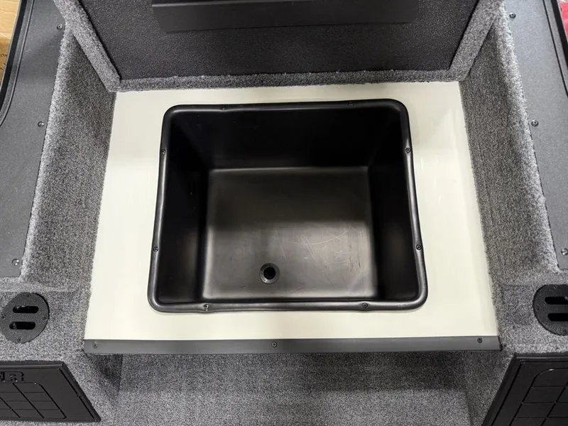 Slide: The Image of 2025 Tracker Savage 215 boat storage compartment with black interior. - 10