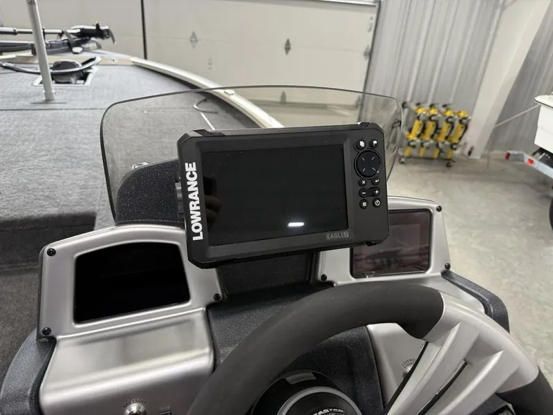 Slide: The Image of 2025 Tracker Savage 215 boat dashboard with Lowrance fish finder display. - 12